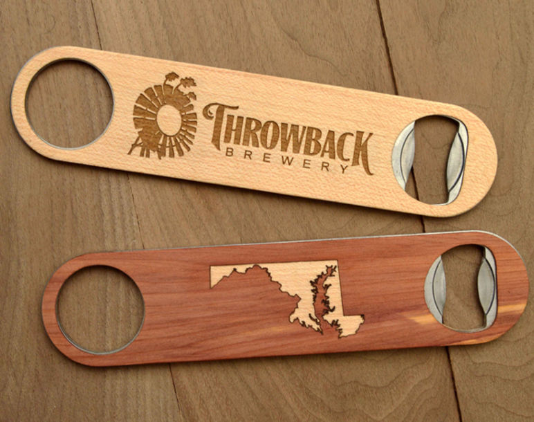 Two wooden beer bottle openers, one engraved with 'Throwback Brewery' and the other featuring a Maryland state outline design.